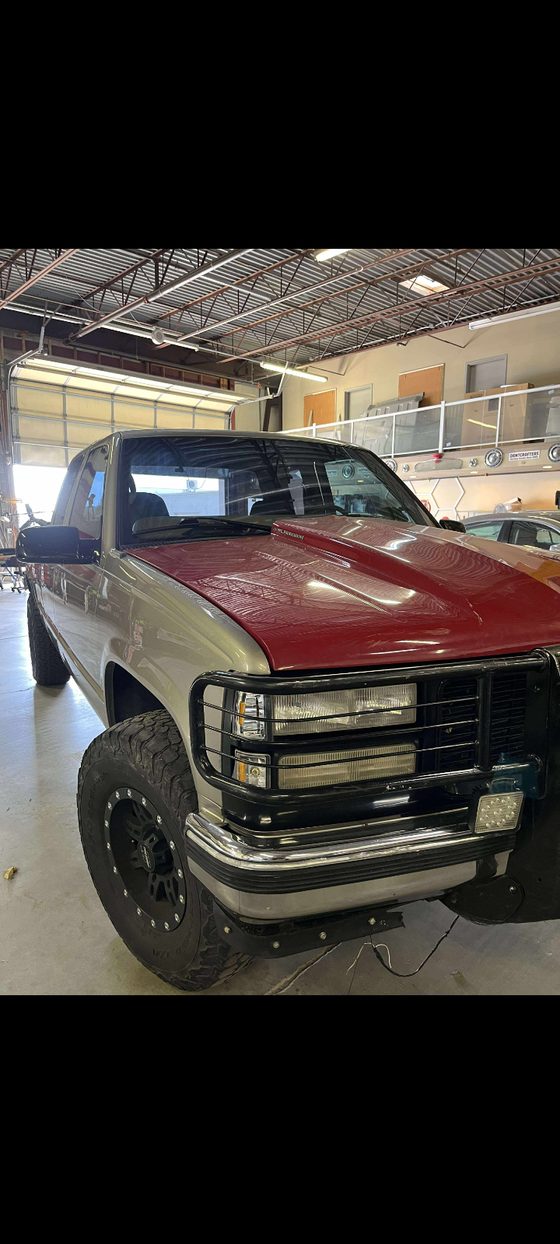 Two-tone pickup truck with a brush guard parked inside the A2Z Auto Repair service bay